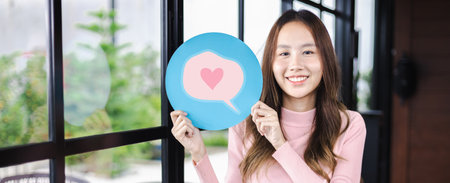 Customer experience review and feedback satisfaction service concept. Woman holding love heart emoji for giving good feedback ratingの写真素材