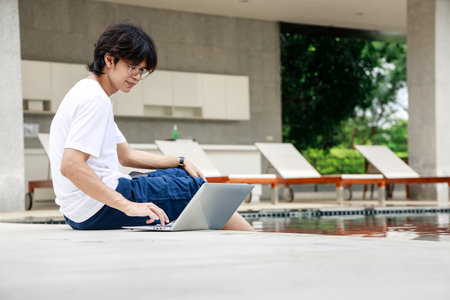 Casual Business Attire for Remote Work by the Poolside on Vacationの写真素材