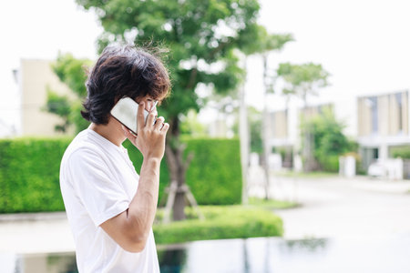 Balancing Work and Leisure, Man Works Remotely by the Pool During Vacationの写真素材