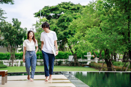 Sun, Fun, and Work, Happy Business Couple Balances Work and Play by the Poolの写真素材