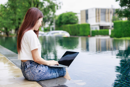 Business Woman trading a stock near swimming pool in a rural hotel. Business Investor, Real estateの写真素材
