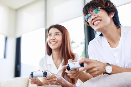 Fun at Home, Couple Playing Video Games Together on Couchの写真素材
