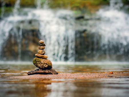 Stacked stones on the background of a waterfall. Zen concept.の写真素材