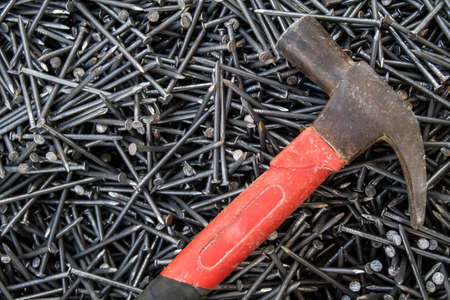 vintage hammer and lot of nails backgroundの写真素材