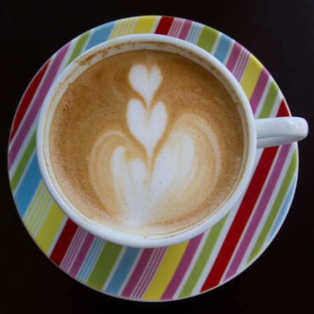 coffee latte art on the color cupの写真素材