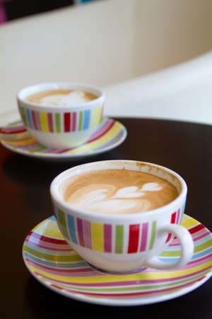 coffee latte art on the color cupの写真素材