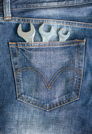 Wrenches in blue jeans pocketの写真素材