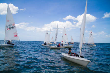 Unidentified sailing competitors in King' cups Hua Hin Regatta 2012 - Hua Hin Beach near Hyatt Hotel on August 11, 2012 in Hua Hin, Thailandのeditorial素材