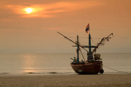 Fisher boat on Hua Hin beach  sunrise background Thailandの写真素材