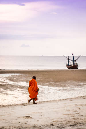 Monk walking on the beach Hua Hin Thailandの写真素材