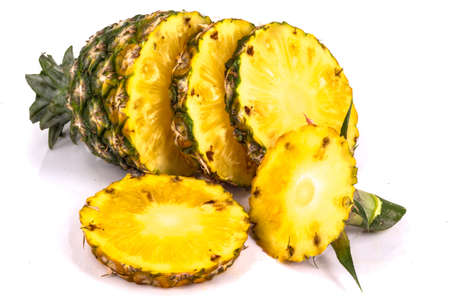 Pineapple with slices on white backgroundの写真素材