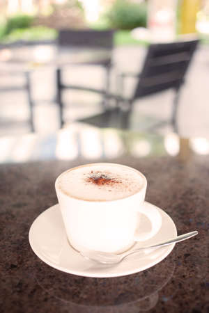 cup of coffee with milk warm tone close up の写真素材