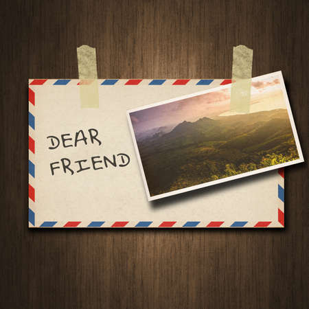 Old vintage style envelope and postcard on wood backgroundの写真素材