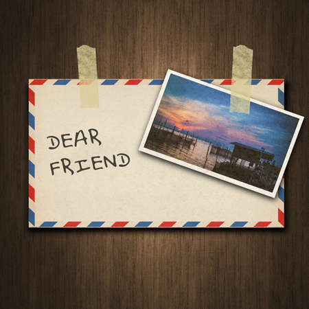 Old vintage style envelope and postcard on wood backgroundの写真素材