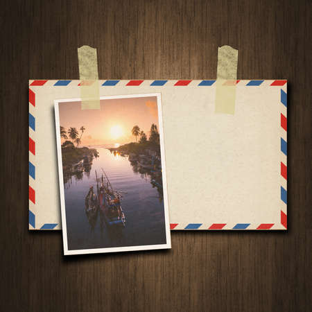 Old vintage style envelope and postcard on wood backgroundの写真素材