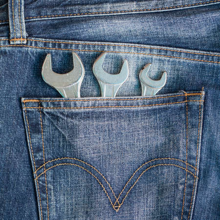 Wrenches in blue jeans pocketの写真素材
