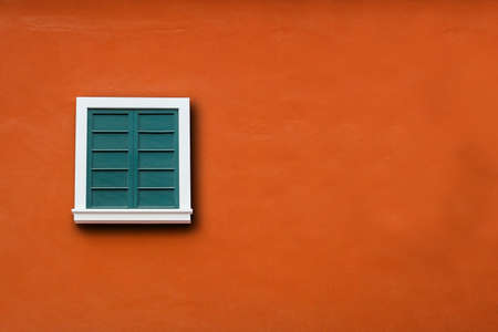 vintage windows on the orange wallの写真素材