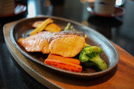 Grilled salmon steak with vegetablesの写真素材