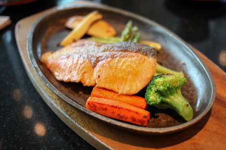 Grilled salmon steak with vegetablesの写真素材