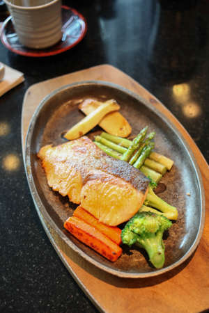 Grilled salmon steak with vegetablesの写真素材