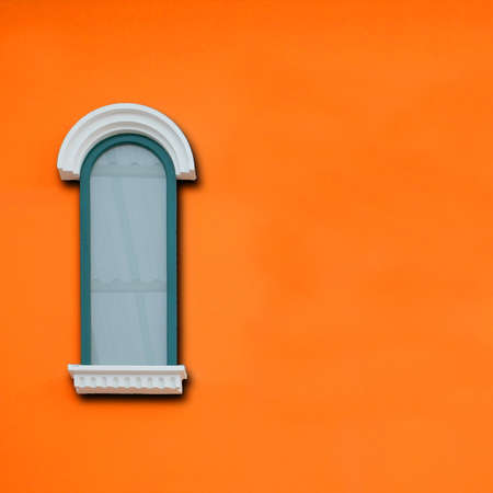 vintage windows on the orange wallの写真素材