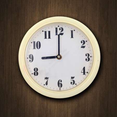 nine o'clock on the wall clock  wood background