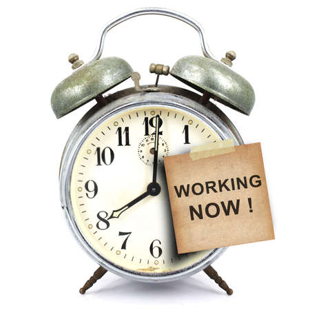 vintage retro alarm clock and text working  now  on the old paper short note isolated white backgroundの写真素材