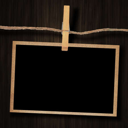 old photo and clothes peg wood backgroundの写真素材