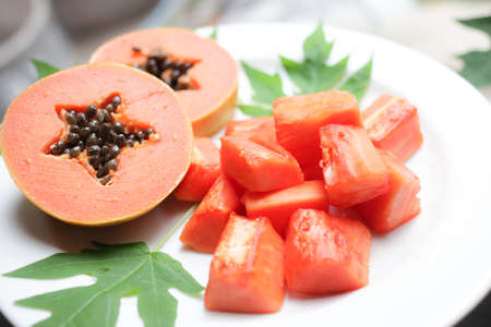 sweet papaya on the dish with green papaya leafの写真素材