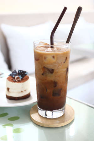 ice coffee and tiramisu cake on the coffee shopの写真素材