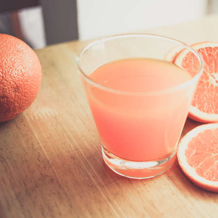 orange juice and on wood desk