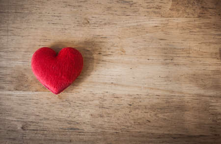 red heart on the vintage wood desk backgroundの写真素材