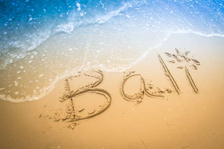 bali  written in a sandy tropical beachの写真素材