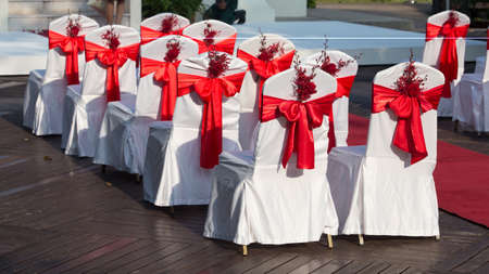 wedding chairs decorated with red rosesの写真素材