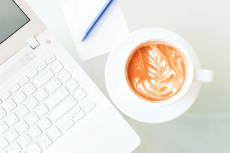 a cup of coffee and a laptop