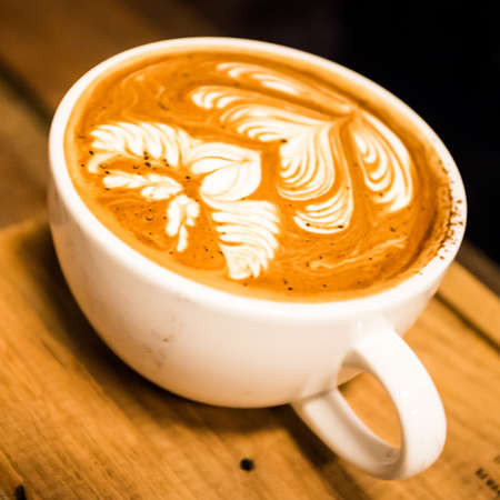 coffee latte art on the wood desk at coffee shopの写真素材