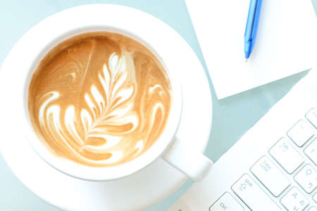 a cup of coffee and a laptopの写真素材