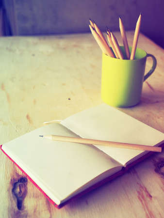 Pencil on the notebook in vintage color toneの写真素材