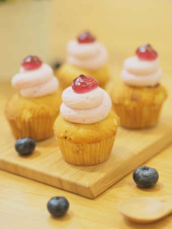 strawberry cupcake on the wooden deskの写真素材