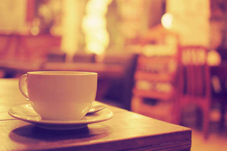 cup of coffee in coffee shop vintage color toneの写真素材