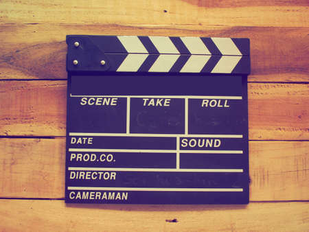 clapper board on wood background vintage color toneの写真素材