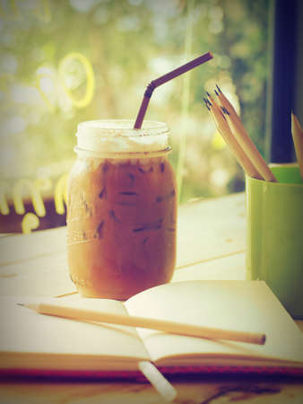 ice coffee on the wood desk  in vintage tone colorの写真素材
