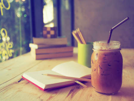 ice coffee on the wood desk  in vintage tone colorの写真素材