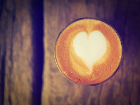 coffee latte on the wood desk vintage color toneの写真素材