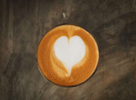 coffee latte on the wood desk vintage color toneの写真素材