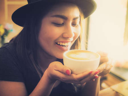 Beautiful Girl Drinking Tea or Coffee in vintage color toned styleのeditorial素材