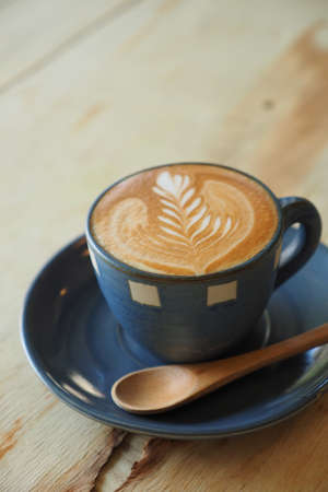 cup of coffee latte art  with book in coffee shop vintage colorの写真素材