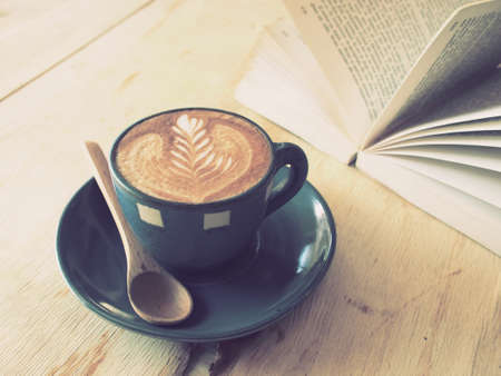 cup of coffee latte art  with book in coffee shop vintage colorの写真素材