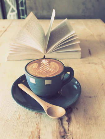 cup of coffee latte art  with book in coffee shop vintage colorの写真素材