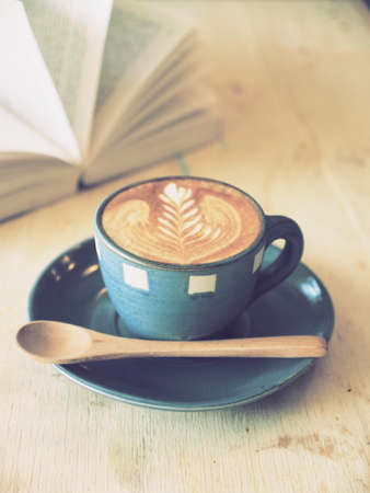cup of coffee latte art  with book in coffee shop vintage colorの写真素材